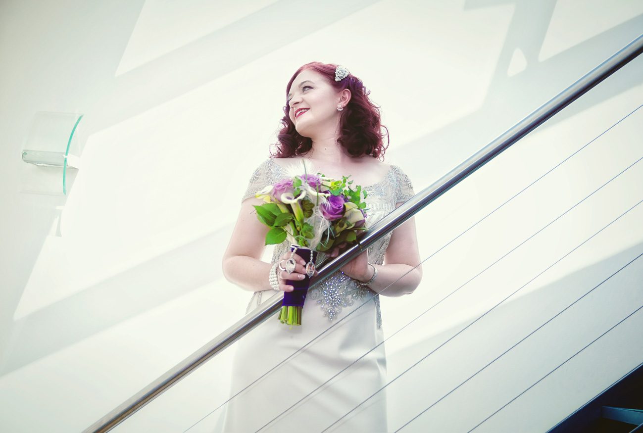 Islington wedding bride poses on metal stairs