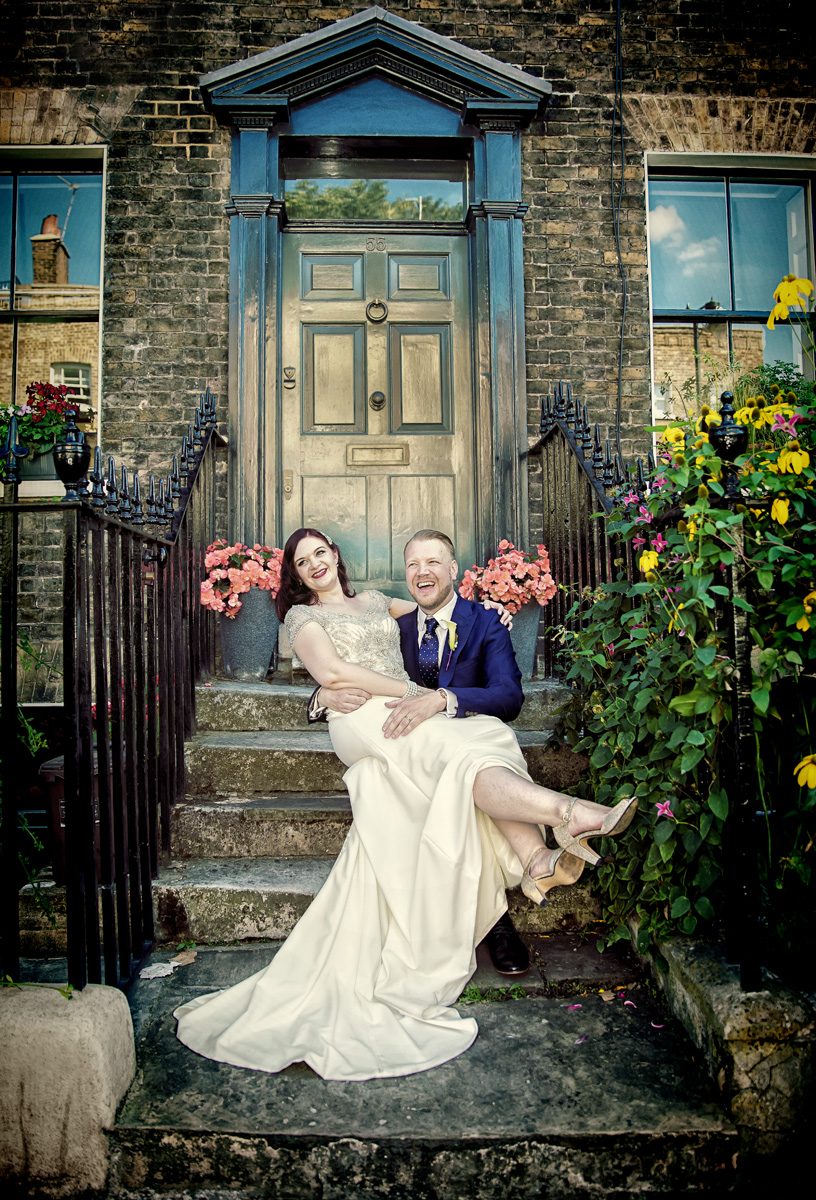 Islington wedding couple sit and laugh on London steps image