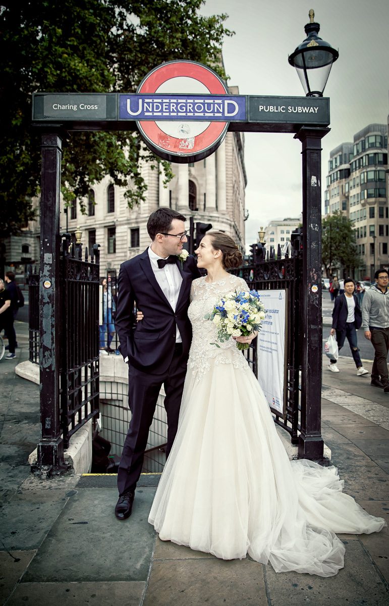 London wedding couple by Charing Cross Tube station entrance
