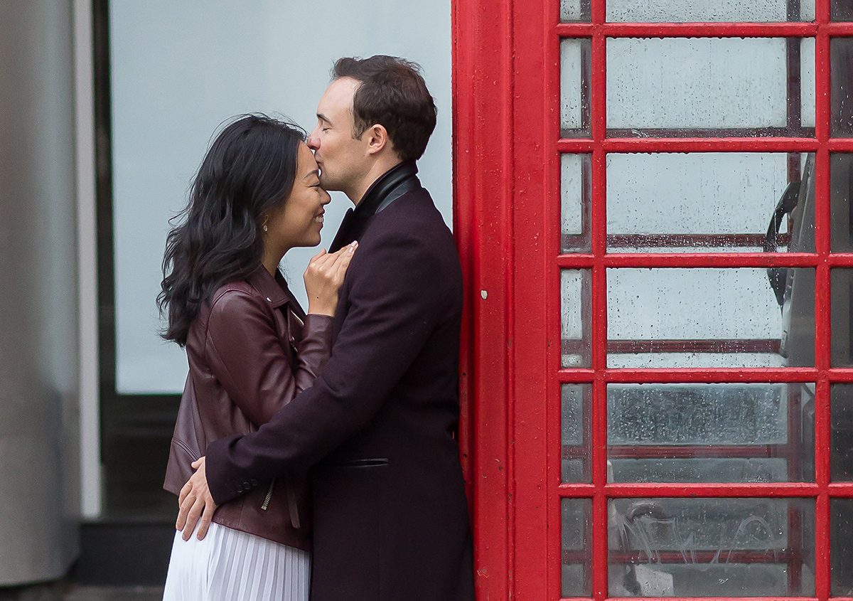 London engagement shoot couple embrace by red phone box