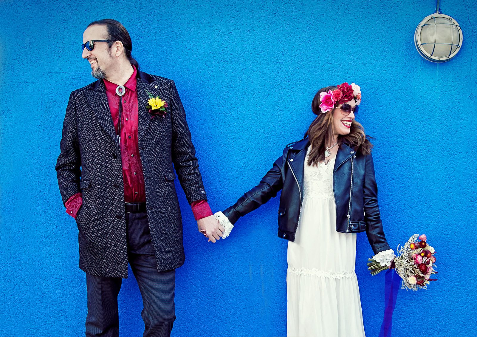 Islington bride and groom hand in hand by blue wall image