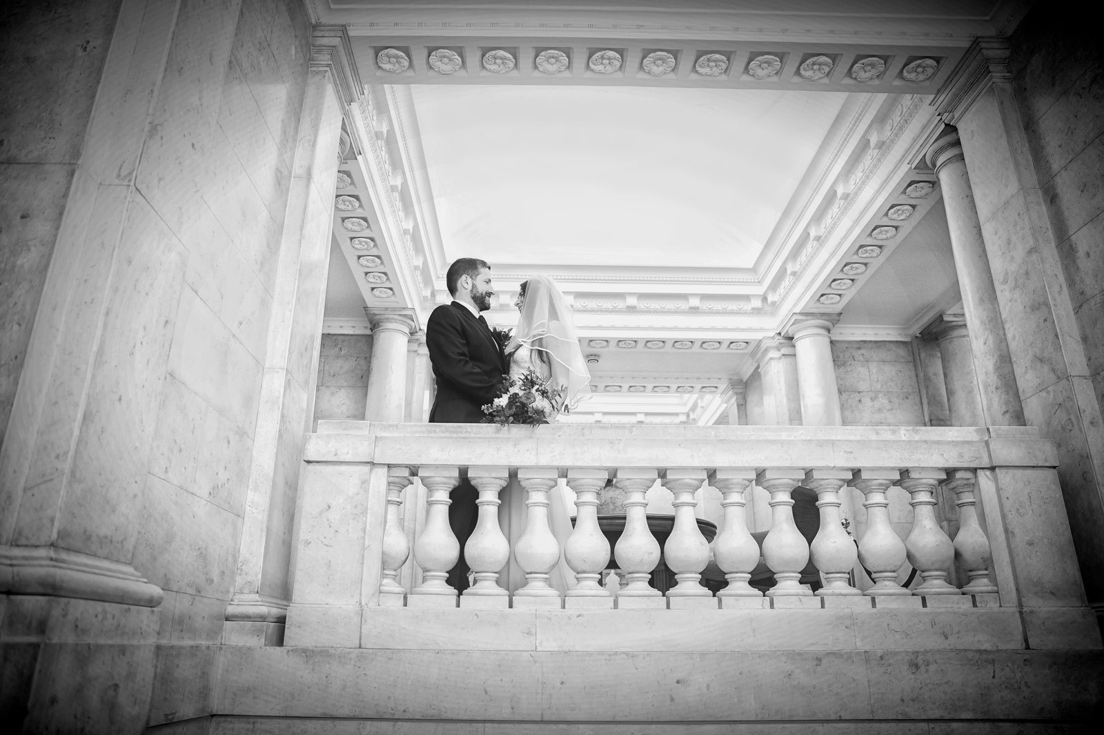 Wedding couple on balcony inside Old Marylebone Town Hall