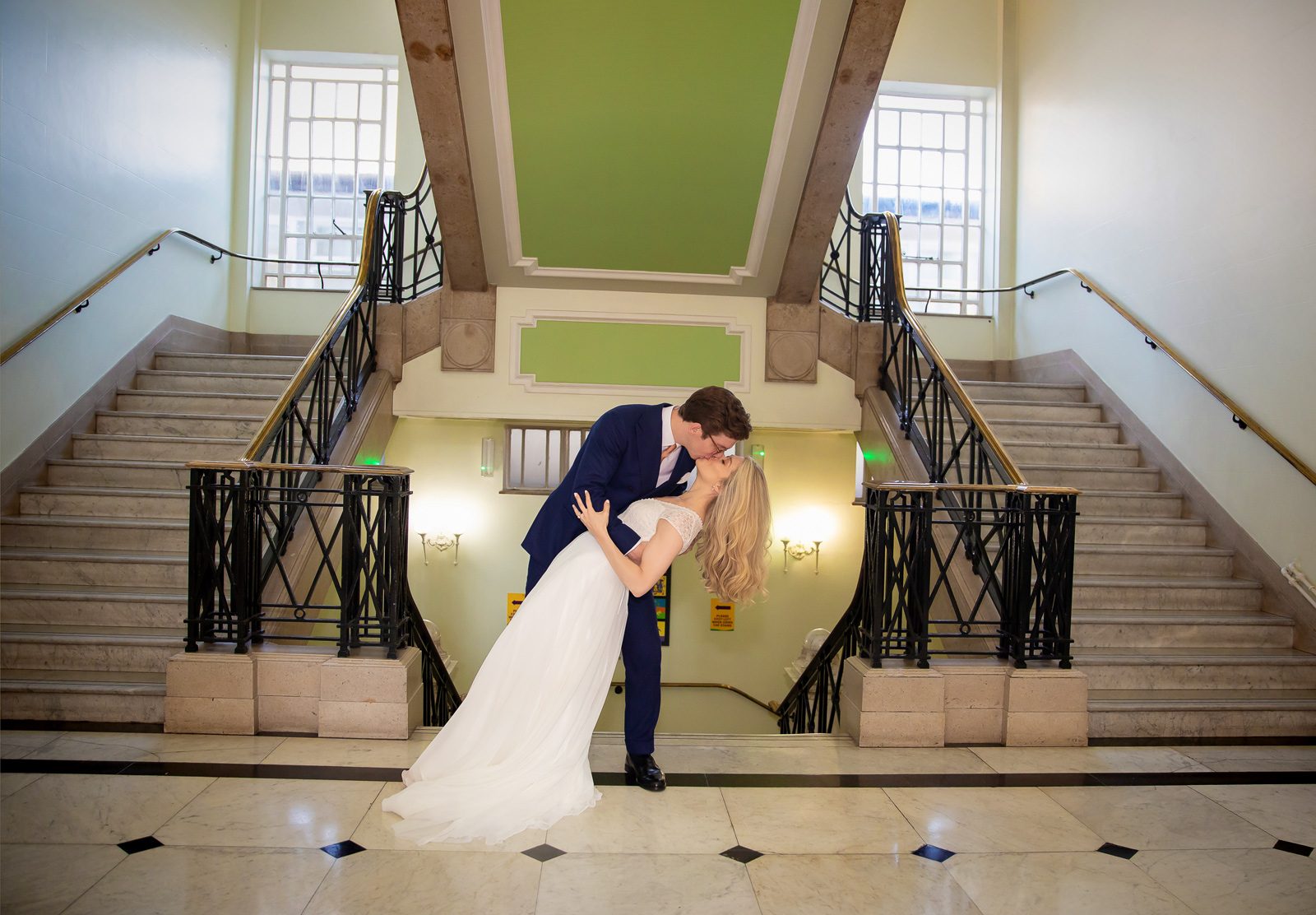 Couple kiss by stairs Islington Town Hall wedding