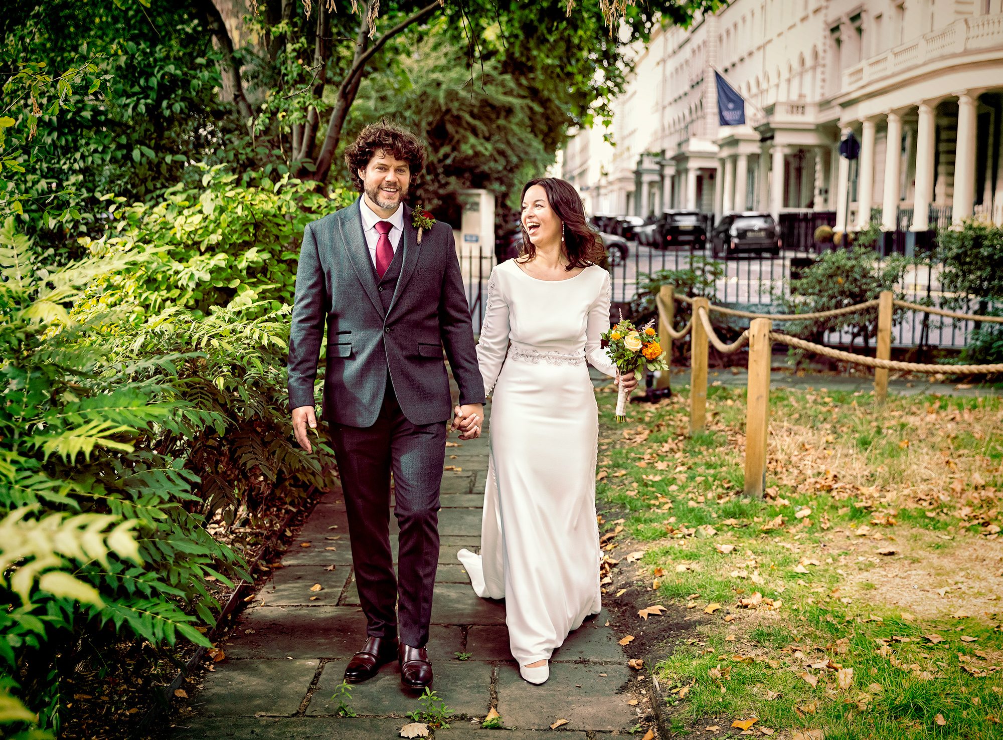 Bride and groom walk through gardens Paddington wedding