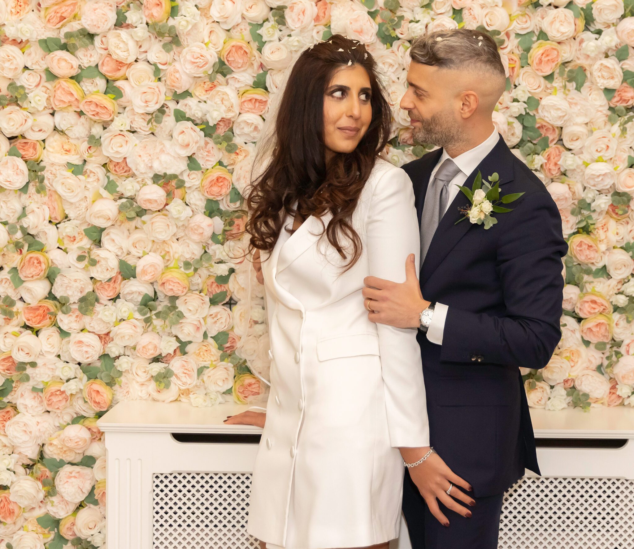 Couple by flowers at Chelsea Old Town Hall wedding