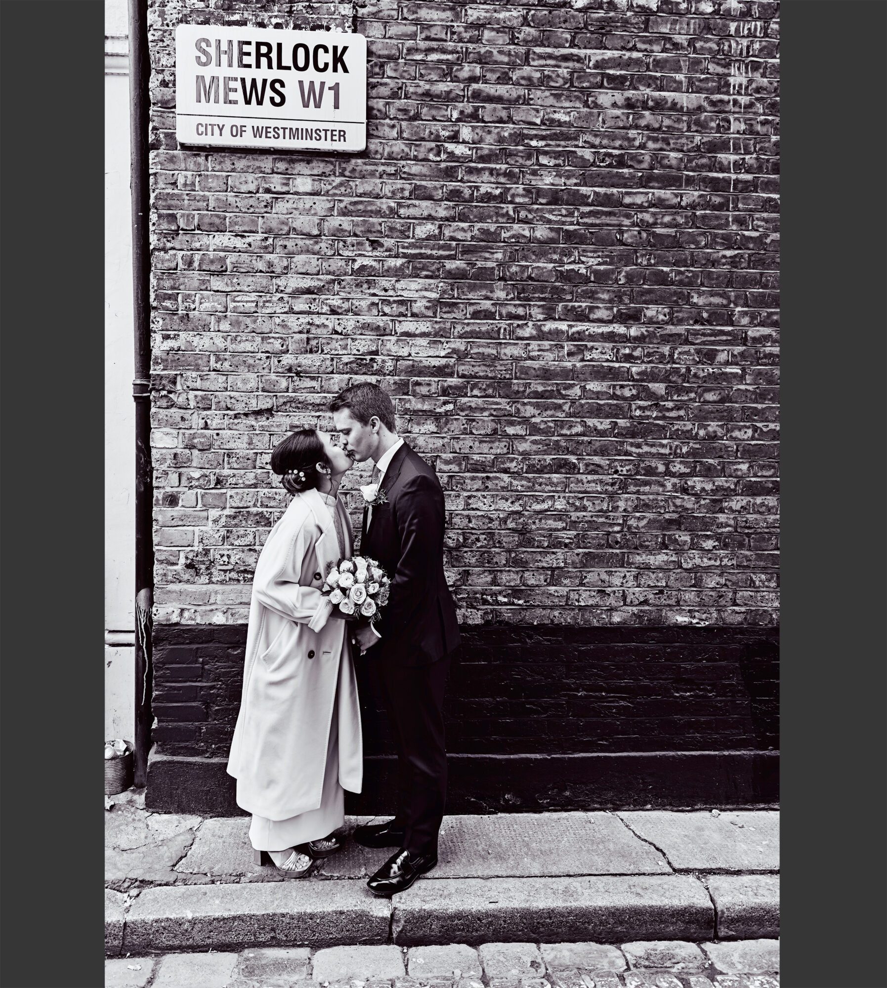 London wedding couple kiss on street near Marylebone Old Town Hall